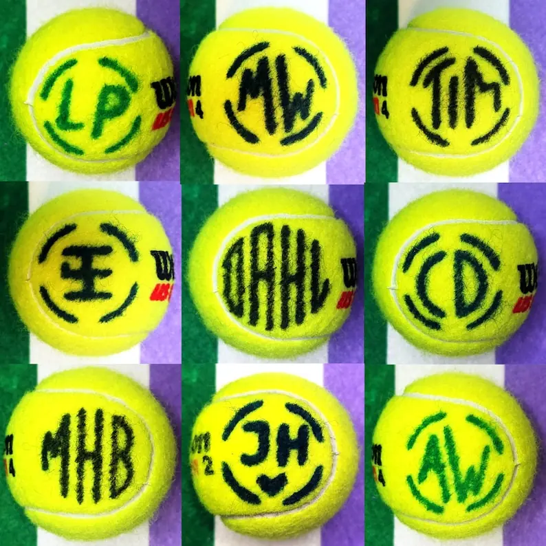 A grid of tennis balls marked with different custom initials and logos